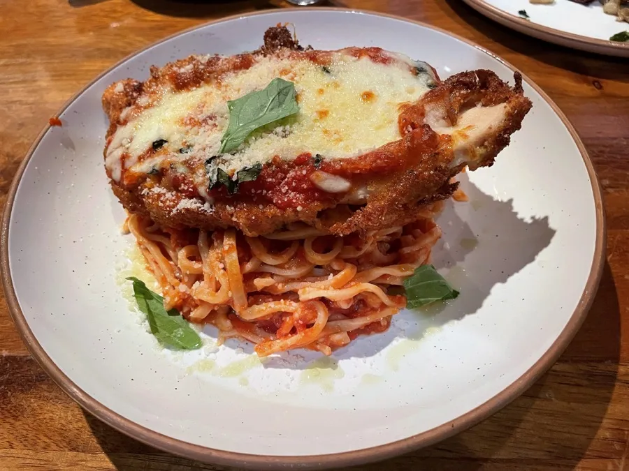 Chicken parmigiana over linguini